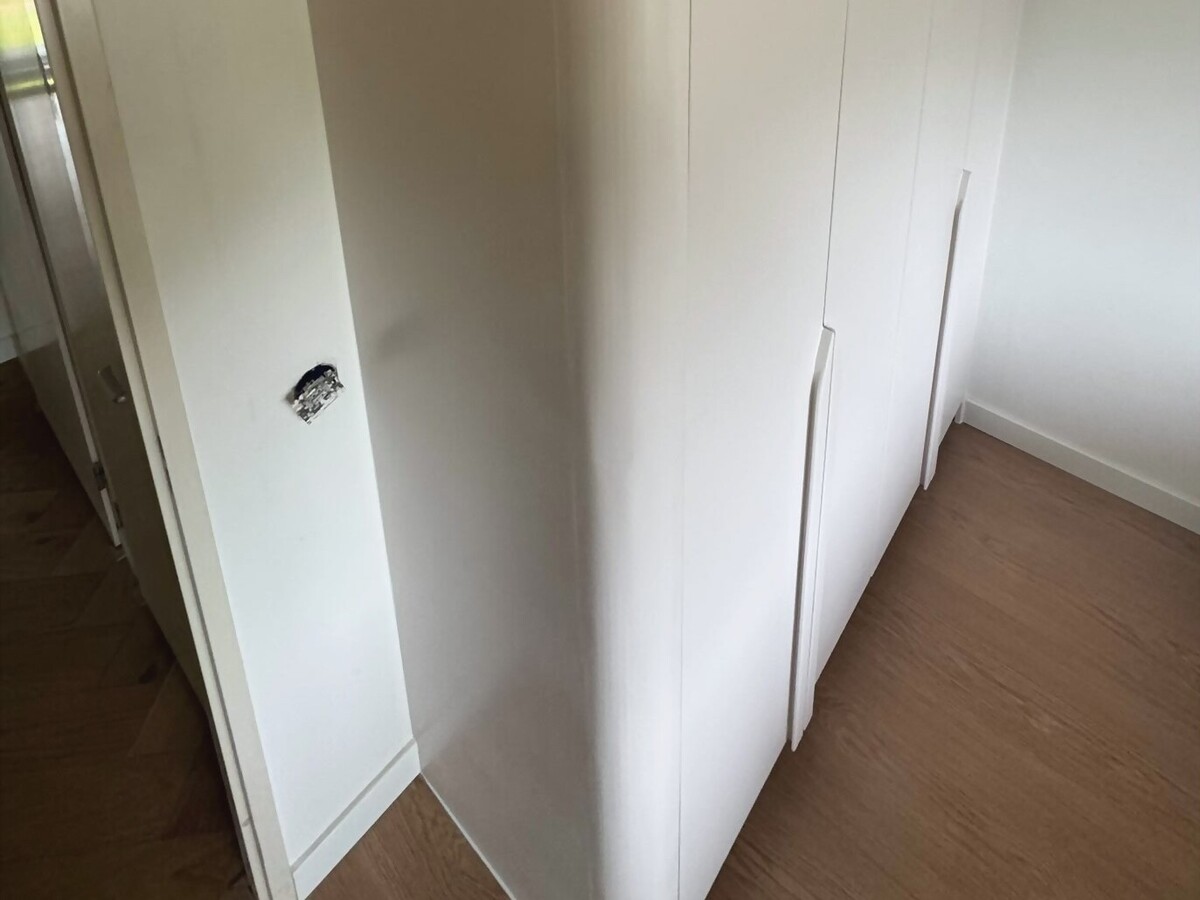 Curved floor-to-ceiling wardrobe — Custom wardrobe for a home.